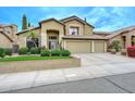 View of front yard, two-story home featuring a well-manicured front yard and a spacious three-car garage at 23046 N 21St St, Phoenix, AZ 85024