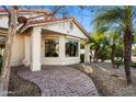 Inviting front entrance with a brick pathway leading to the home's entryway at 2336 Leisure World --, Mesa, AZ 85206