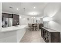 Open concept kitchen with island and adjacent dining area at 2511 W Queen Creek Rd # 415, Chandler, AZ 85248