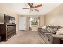 Living room with a grey couch and ceiling fan at 2526 N 22Nd Dr, Phoenix, AZ 85009