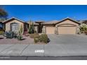 House exterior featuring a two-car garage and desert landscaping at 26646 N 46Th Pl, Cave Creek, AZ 85331