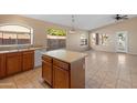 Bright kitchen with island, tile floors, and ample cabinetry at 2805 N 111Th Dr, Avondale, AZ 85392