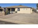 Charming single-story home with a spacious driveway and a fenced yard at 302 E Beech Ave, Casa Grande, AZ 85122