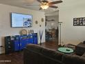 Bright and airy living room with hardwood floors, a large TV, and comfortable seating at 302 E Beech Ave, Casa Grande, AZ 85122