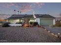 Front view of a charming one-story house with solar panels at 3036 W Gail Rd, Phoenix, AZ 85029