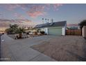 House exterior showcasing a large green garage door and driveway at 3036 W Gail Rd, Phoenix, AZ 85029