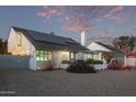 A white house with solar panels and a unique architectural style at 3036 W Gail Rd, Phoenix, AZ 85029