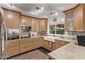 Modern kitchen with light wood cabinets and granite countertops at 3036 W Gail Rd, Phoenix, AZ 85029