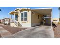 Front view of a yellow manufactured home with carport and landscaping at 305 S Val Vista Dr # 71, Mesa, AZ 85204