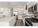 Modern kitchen with stainless steel appliances and white cabinets at 305 S Val Vista Dr # 71, Mesa, AZ 85204