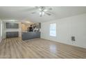 Open living area with laminate flooring and ceiling fan at 3100 W Quail Rd, Eloy, AZ 85131