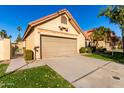 Tan stucco house with a two-car garage and gated entryway at 4698 W Harrison St, Chandler, AZ 85226