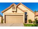 Tan stucco house with a two-car garage and driveway at 4698 W Harrison St, Chandler, AZ 85226