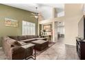 Spacious living room featuring a large sectional sofa and tile flooring at 5317 W Glenview Pl, Chandler, AZ 85226