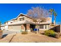 Two-story house with a three-car garage and mature trees at 544 W Sierra Madre Ave, Gilbert, AZ 85233