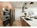 Sleek kitchen featuring stainless steel appliances and wood cabinets at 7120 E Kierland Blvd # 311, Scottsdale, AZ 85254