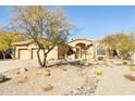 One-story home with a two-car garage and drought-tolerant landscaping at 7126 E Bobwhite Way, Scottsdale, AZ 85266