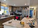 Spacious kitchen featuring modern appliances and an island at 7300 N 51St Ave, Glendale, AZ 85301