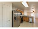 Kitchen with stainless steel appliances and oak cabinets at 7334 S Morning Dew Ln, Buckeye, AZ 85326