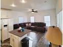 Bright living room with wood laminate flooring, and a leather sofa at 7807 E Main St # F36, Mesa, AZ 85207