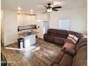 Open-concept living room and kitchen with island, natural light, and modern decor at 7807 E Main St # F36, Mesa, AZ 85207