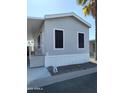 Side view of gray manufactured home with window coverings at 7807 E Main St # Ofc, Mesa, AZ 85207