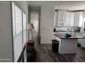 Open concept kitchen features white cabinets and an island at 7807 E Main St # Ofc, Mesa, AZ 85207