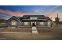 Stylish modern farmhouse with black trim, neutral stone accents, and a desert landscape at 8169 E Redberry --, Mesa, AZ 85207