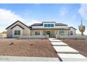 Beautiful modern farmhouse featuring black trim, stone accents, and desert landscaping at 8169 E Redberry --, Mesa, AZ 85207