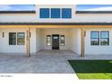 Inviting front porch with a black door, modern tile, and stone columns at 8169 E Redberry --, Mesa, AZ 85207