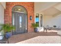 Dark gray front door with arched window and sidelights at 922 E Desert Hills Estate Dr, Phoenix, AZ 85086