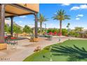 Luxury backyard with pool, putting green, and covered patio at 9255 W Buckskin Trl, Peoria, AZ 85383