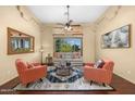 Bright and airy living room featuring comfortable seating and a large window at 9255 W Buckskin Trl, Peoria, AZ 85383