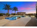 Inviting pool and patio area with palm trees at 9255 W Buckskin Trl, Peoria, AZ 85383