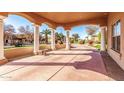 Spacious covered patio with columns and a stone bench, overlooking a manicured yard at 928 E Valencia Dr, Phoenix, AZ 85042