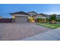 Curb appeal abounds in this inviting home showcasing a large driveway and meticulous landscaping at 9343 W Cashman Dr, Peoria, AZ 85383