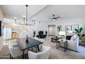 Open concept dining area with black table and white chairs, adjacent to kitchen at 9455 E Raintree Dr # 2049, Scottsdale, AZ 85260