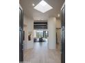 Light-filled entryway with high ceilings, hardwood floors, and views into the living area at 10040 E Happy Valley Rd # 1041, Scottsdale, AZ 85255
