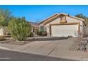 House exterior showcasing a two-car garage and desert landscaping at 10634 W Mohawk Ln, Peoria, AZ 85382