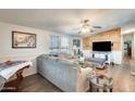 Spacious living room featuring hardwood floors and a wood accent wall at 120 N Val Vista Dr # 186, Mesa, AZ 85213