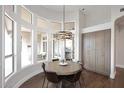 Circular dining area with large windows, chandelier, and a round table for casual meals at 12079 E Cortez Dr, Scottsdale, AZ 85259