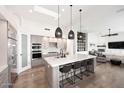 Open-concept kitchen with a large center island, pendant lights, and views of the living area at 12079 E Cortez Dr, Scottsdale, AZ 85259