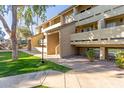 Apartment building exterior showcasing landscaping and walkway at 1331 W Baseline Rd # 251, Mesa, AZ 85202