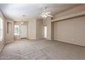 Spacious living room with neutral carpeting and high ceilings at 15144 W Washington St, Goodyear, AZ 85338