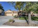 Three-car garage and lovely landscaping in front of the house at 16364 W Roosevelt St, Goodyear, AZ 85338