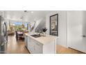Open kitchen with island and view into dining area at 16510 N 92Nd St # 1006, Scottsdale, AZ 85260