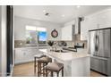 Bright kitchen featuring an island and white cabinetry at 16510 N 92Nd St # 1006, Scottsdale, AZ 85260