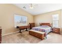Cozy bedroom with wood furniture and carpeted floors at 19339 N Madison Rd, Maricopa, AZ 85139