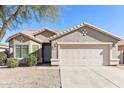 Single-story house with a two-car garage and desert landscaping at 19339 N Madison Rd, Maricopa, AZ 85139