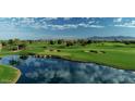 Picturesque golf course with a pond, sand traps, and lush green fairway at 210 E Bergamot Ln, Queen Creek, AZ 85140